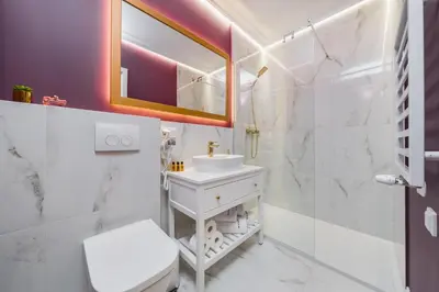 a white bathroom with a sink and a mirror at Art of Serenity in Kraków