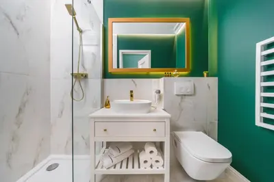 a bathroom with a sink and a toilet and a mirror at Art of Serenity in Kraków