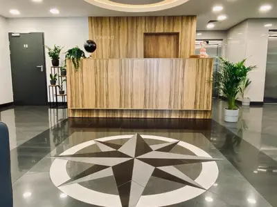 a lobby with a table and a flower on the floor at Hotel CONRAD Comfort in Kraków
