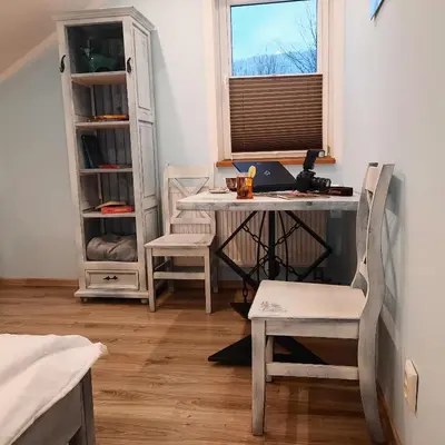 a bedroom with a bed and a table with a lamp at Gościna U kowala in Lachowice