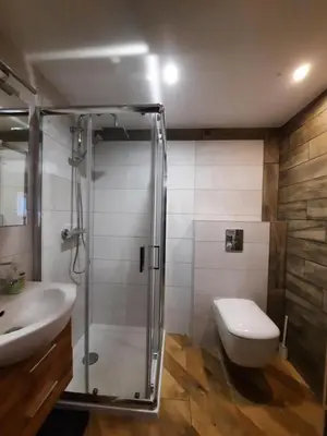 a bathroom with a shower and a toilet and a sink at Gościna U kowala in Lachowice
