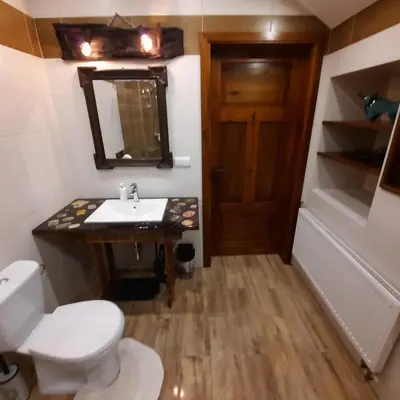 a room with a door and a checkerboard floor at Gościna U kowala in Lachowice