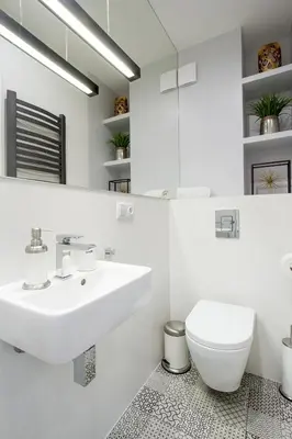 a white bathroom with a sink and a toilet at Old Town Residence at Topolowa in Kraków