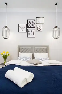 a bedroom with two beds with towels on them at Old Town Residence at Topolowa in Kraków