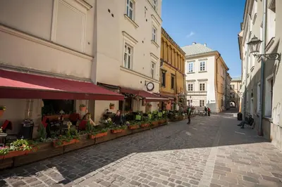 an empty street in a city with buildings at VINTAGE SENACKA APARTAMENTS in Kraków