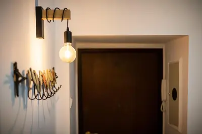 a hallway with a door and a light fixture at VINTAGE SENACKA APARTAMENTS in Kraków