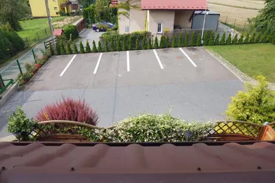 a parking lot with two benches in a yard at Mączne Skały in Biały Kościół