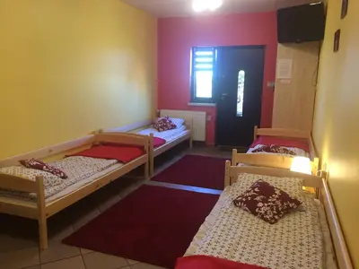 a room with three bunk beds and a door at Mączne Skały in Biały Kościół