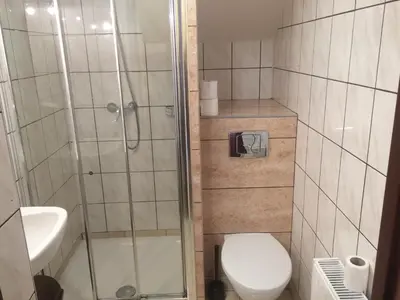 a bathroom with a shower and a toilet and a sink at Mączne Skały in Biały Kościół
