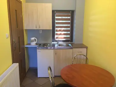 a small kitchen with a table and a sink at Mączne Skały in Biały Kościół