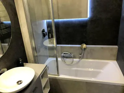 a bathroom with a shower and a sink and a toilet at Glamour Apartment with big, private terrace in Kraków