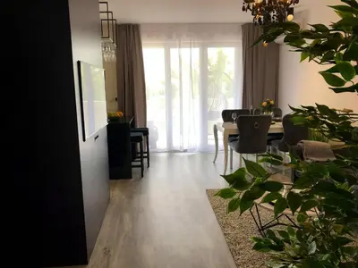 a living room with a table and a dining room at Glamour Apartment with big, private terrace in Kraków