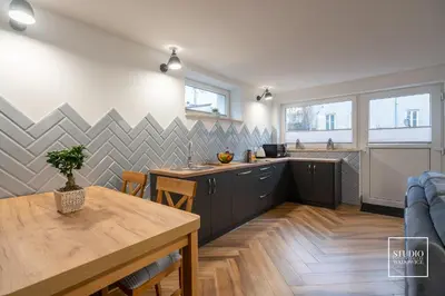 a kitchen with a table and a counter top at Exclusive Apartment Centrum in Wadowice