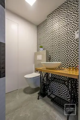 a bathroom with a sink and a toilet and a wall at Exclusive Apartment Centrum in Wadowice