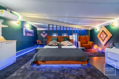 a bedroom with a large bed and a couch at Exclusive Apartment Centrum in Wadowice