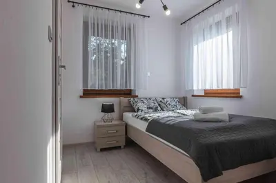 a bedroom with a bed and a window at Dworek na Zakręcie - noclegi Zator in Zator