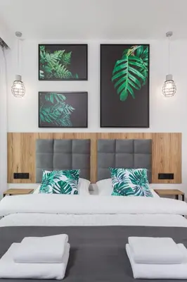 a bedroom with a large bed with green leaves at City of the Kings - City Point Green - Rajska 3 in Kraków