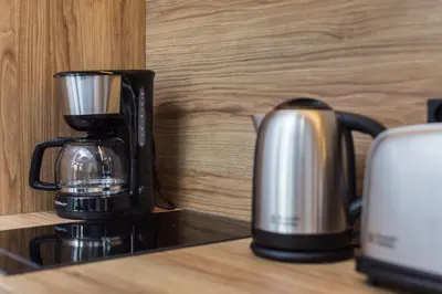 a coffee maker sitting on top of a counter at City of the Kings - City Point Green - Rajska 3 in Kraków