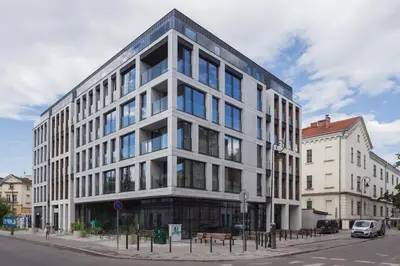 a large white building on a city street at City of the Kings - City Point Green - Rajska 3 in Kraków