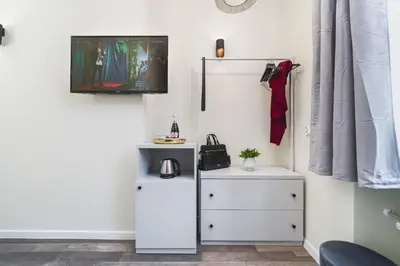 a room with a white cabinet and a mirror at Liv Apartments Old Town in Kraków