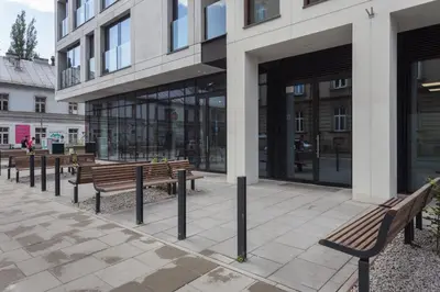 a group of benches in front of a building at City of the Kings - Asja Apartment - Rajska 3 in Kraków