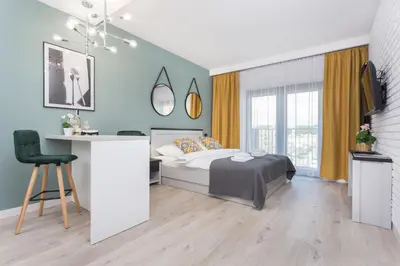 a bedroom with a bed and a desk with a chair at City of the Kings - Asja Apartment - Rajska 3 in Kraków