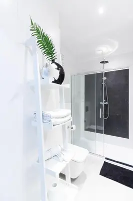 a white bathroom with a toilet and a shower at Rayska Loft Krakow by AS Apartments in Kraków
