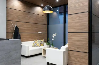 a lobby with wood paneling and white furniture at Rayska Loft Krakow by AS Apartments in Kraków