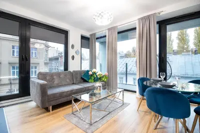 a living room with a couch and a table at Rayska Loft Krakow by AS Apartments in Kraków