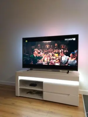 a flat screen tv sitting on a white entertainment center at Rayska Loft Krakow by AS Apartments in Kraków