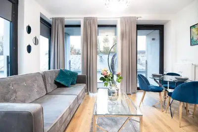 a living room with a couch and a table at Rayska Loft Krakow by AS Apartments in Kraków