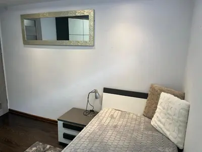 a bedroom with a bed and a mirror on the wall at Premium Terrace Apartament in Kraków