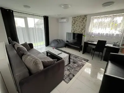 a living room with a couch and a television at Premium Terrace Apartament in Kraków