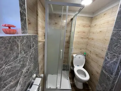 a bathroom with a toilet and a glass shower at Premium Terrace Apartament in Kraków