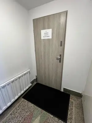 an empty room with a door with a sign on it at Premium Terrace Apartament in Kraków