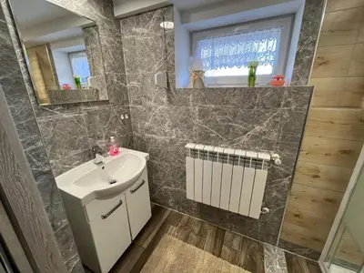a bathroom with a sink and a mirror at Premium Terrace Apartament in Kraków