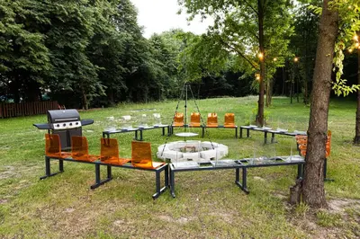 a display of chairs and tables in a park at Motel OLIV in Oświęcim