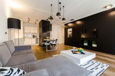 a living room with a couch and a table at Central Kazimierz Apartment with balcony in Kraków