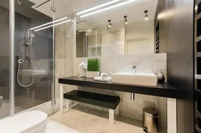 a bathroom with a sink and a shower at Central Kazimierz Apartment with balcony in Kraków