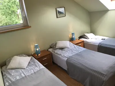 a bedroom with two beds and a window at APARTAMENTY-STUDIO noclegi wczasy wakacje ferie - pobyty rodzinne in Rabka