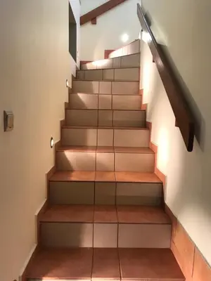 a staircase with wood treads and a glass railing at APARTAMENTY-STUDIO noclegi wczasy wakacje ferie - pobyty rodzinne in Rabka