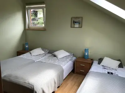 a bedroom with two beds and a window at APARTAMENTY-STUDIO noclegi wczasy wakacje ferie - pobyty rodzinne in Rabka