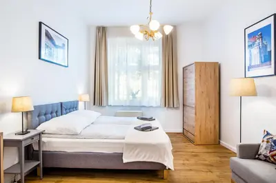 a bedroom with a bed and a couch at Apartament Na Groblach in Kraków