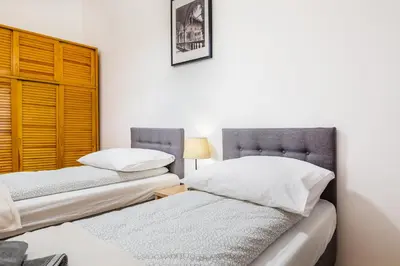 two beds sitting next to each other in a room at Apartament Na Groblach in Kraków
