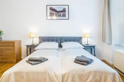 a bedroom with two beds with towels on them at Apartament Na Groblach in Kraków