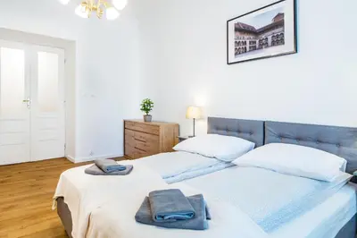 a bedroom with two beds with towels on them at Apartament Na Groblach in Kraków