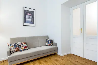a couch sitting in a living room next to a door at Apartament Na Groblach in Kraków