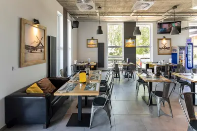 a restaurant dining room with tables and chairs at Apartamenty Szlachecki Dwór in Pobiednik Wielki