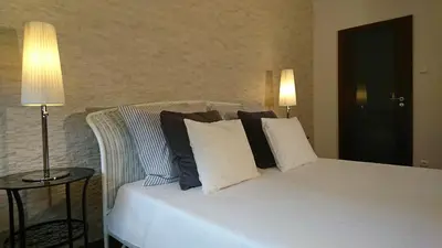 a white bed with black and white pillows on it at Quiet and spacious apartment with garage option in Kraków