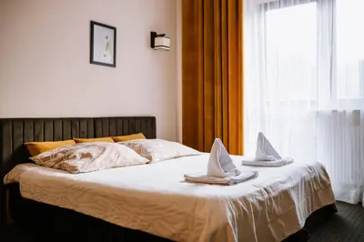 a bed with two hats on top of it at Ośrodek Szkoleniowo Wypoczynkowy ROŻNÓW in Rożnów